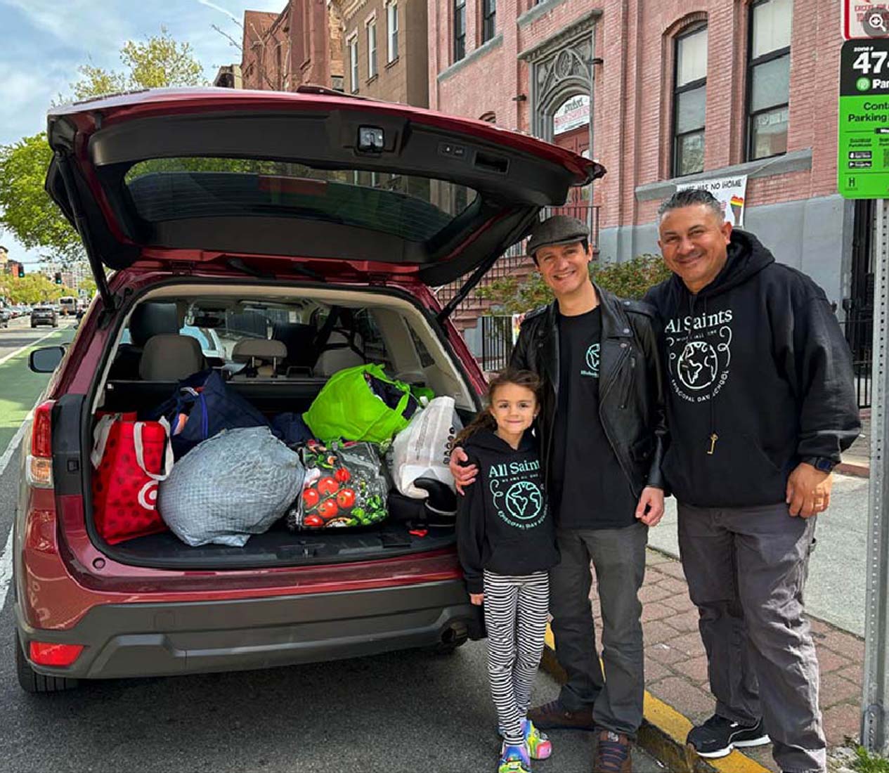 All Saints volunteers loading up their hatchback with good to be delivered